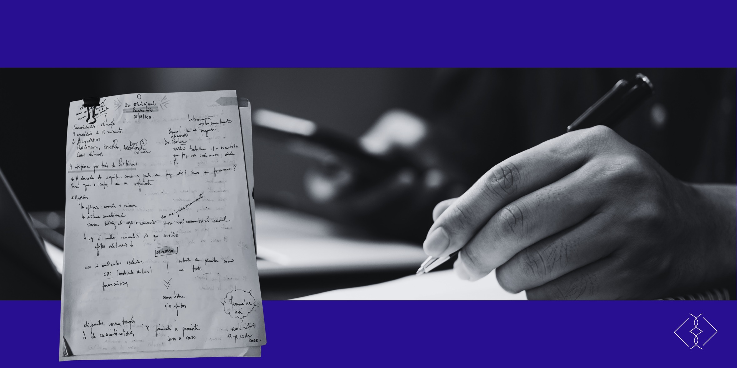 Hand writing in a notebook next to a sheet with handwritten notes, black and white, purple background